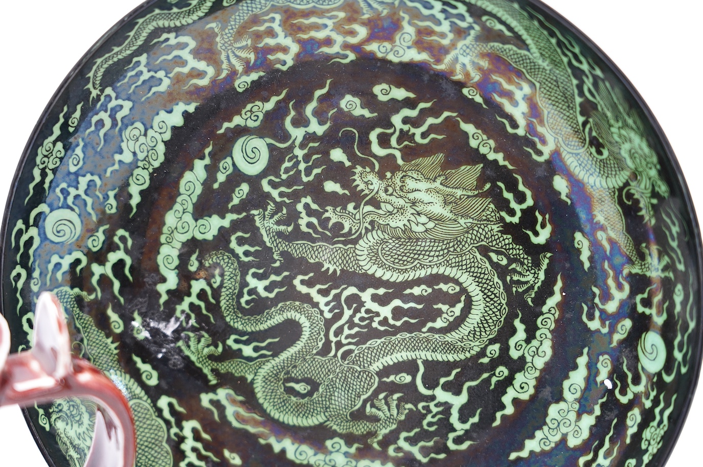 A Chinese famille noire ‘dragon’ dish, 22.5cm diameter, and a Sang de boeuf glaze monk’s cap ewer, Condition - good